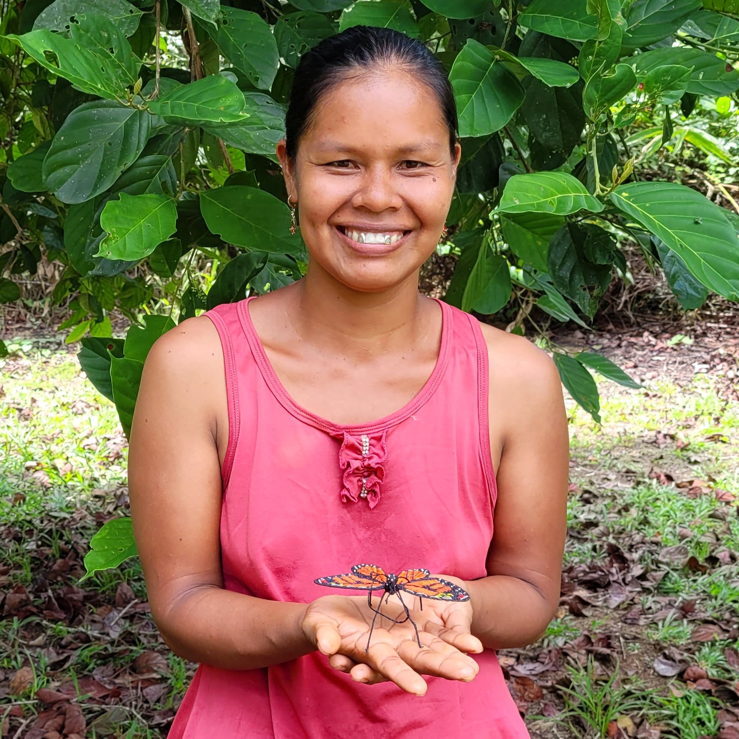 Bora artisan Maria with woven chambira monarch butterfly at Brillo Nuevo