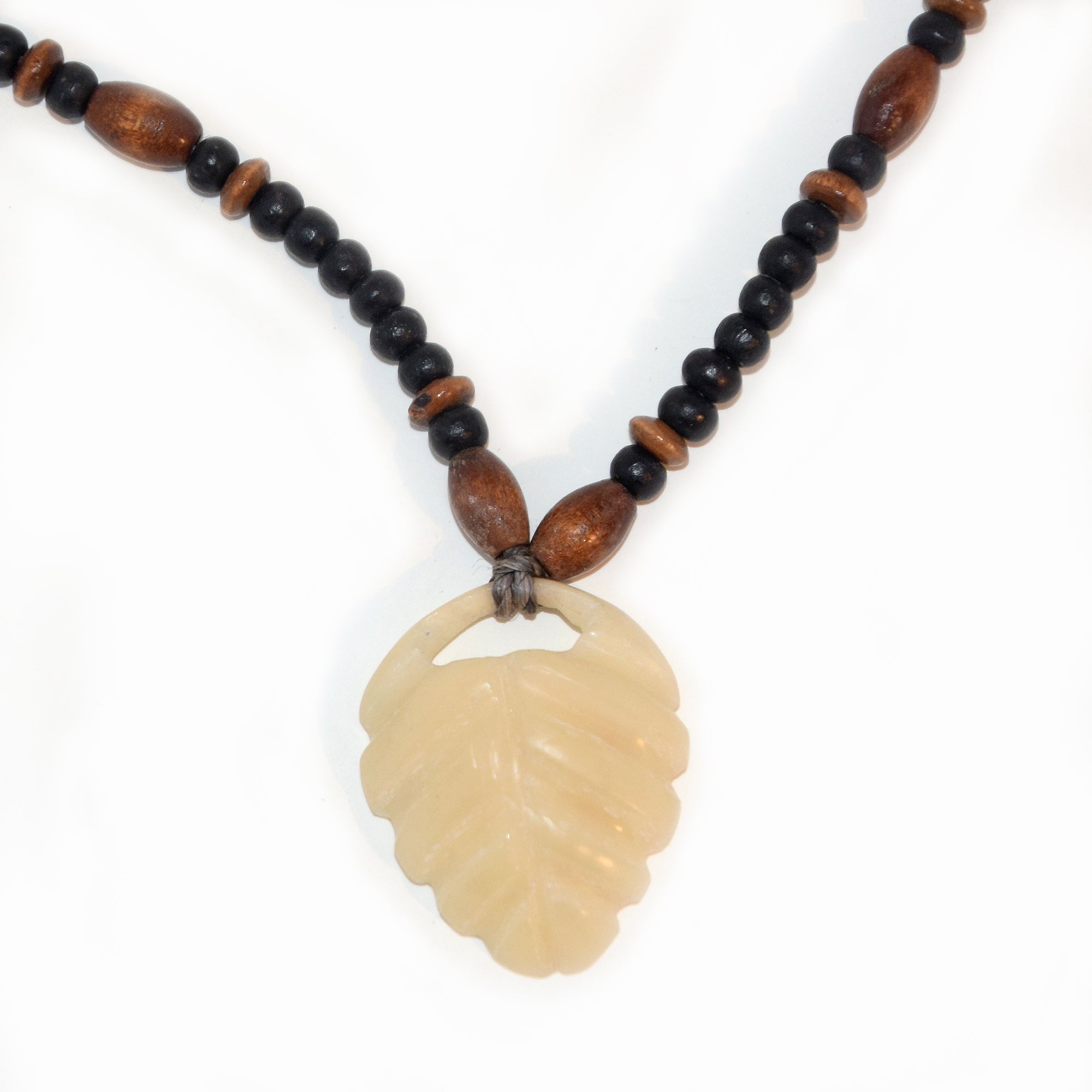Carved tagua palm nut pendant and wooden bead necklace