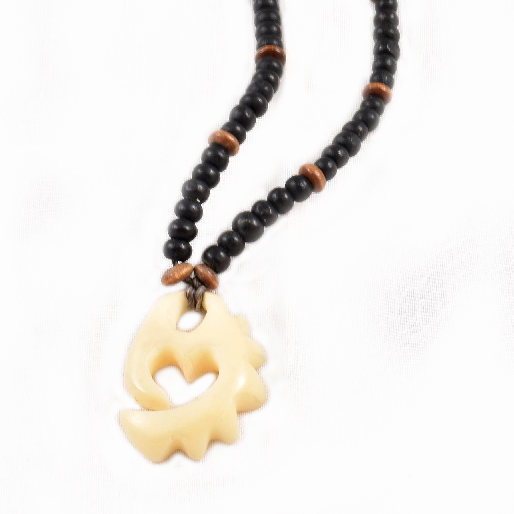 Carved tagua palm nut pendant and wooden bead necklace