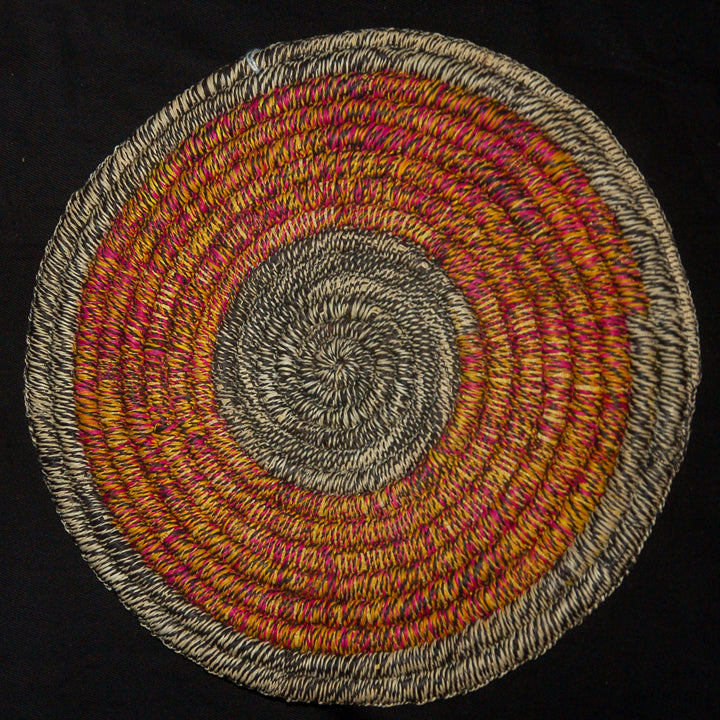Woven hot pad (trivet) and center piece with blended pink and yellow rings